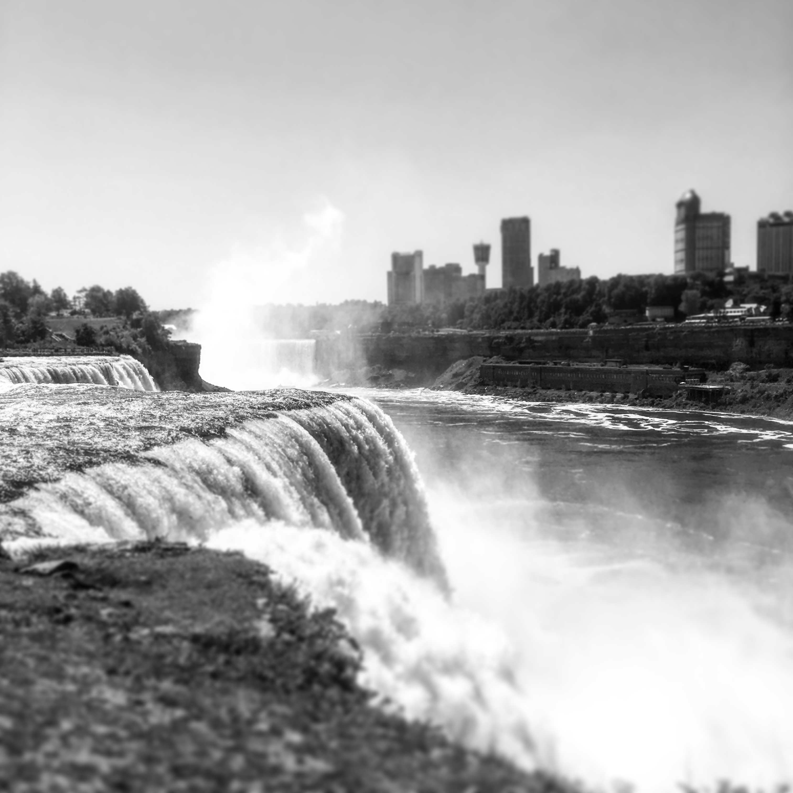 rushing waterfall and distant city, Niagara Falls, US, 2016